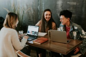 Three Gen Z employees working in a relaxed indoor setting as part of their organisation's EVP offering.
