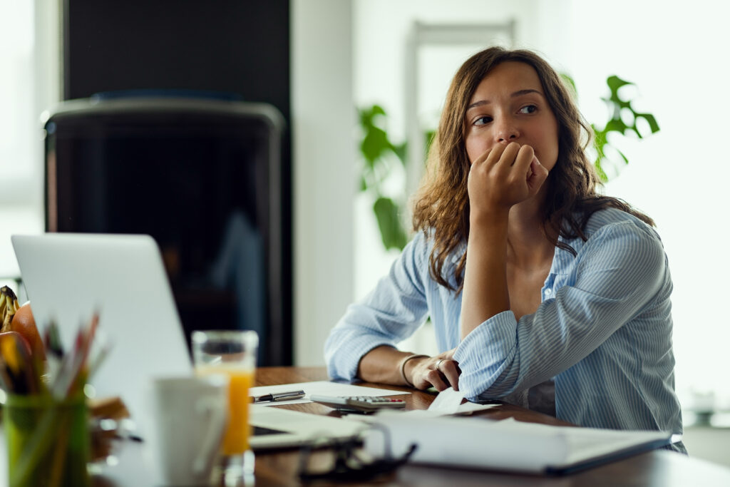 Woman worried and thinking in an office setting. Image credit: Drazen Zigic