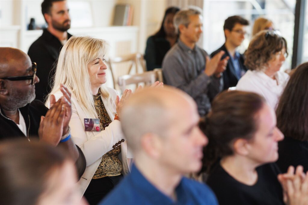 Guests applaud the panelists at the Blue Goose Briefing event about change and transformation