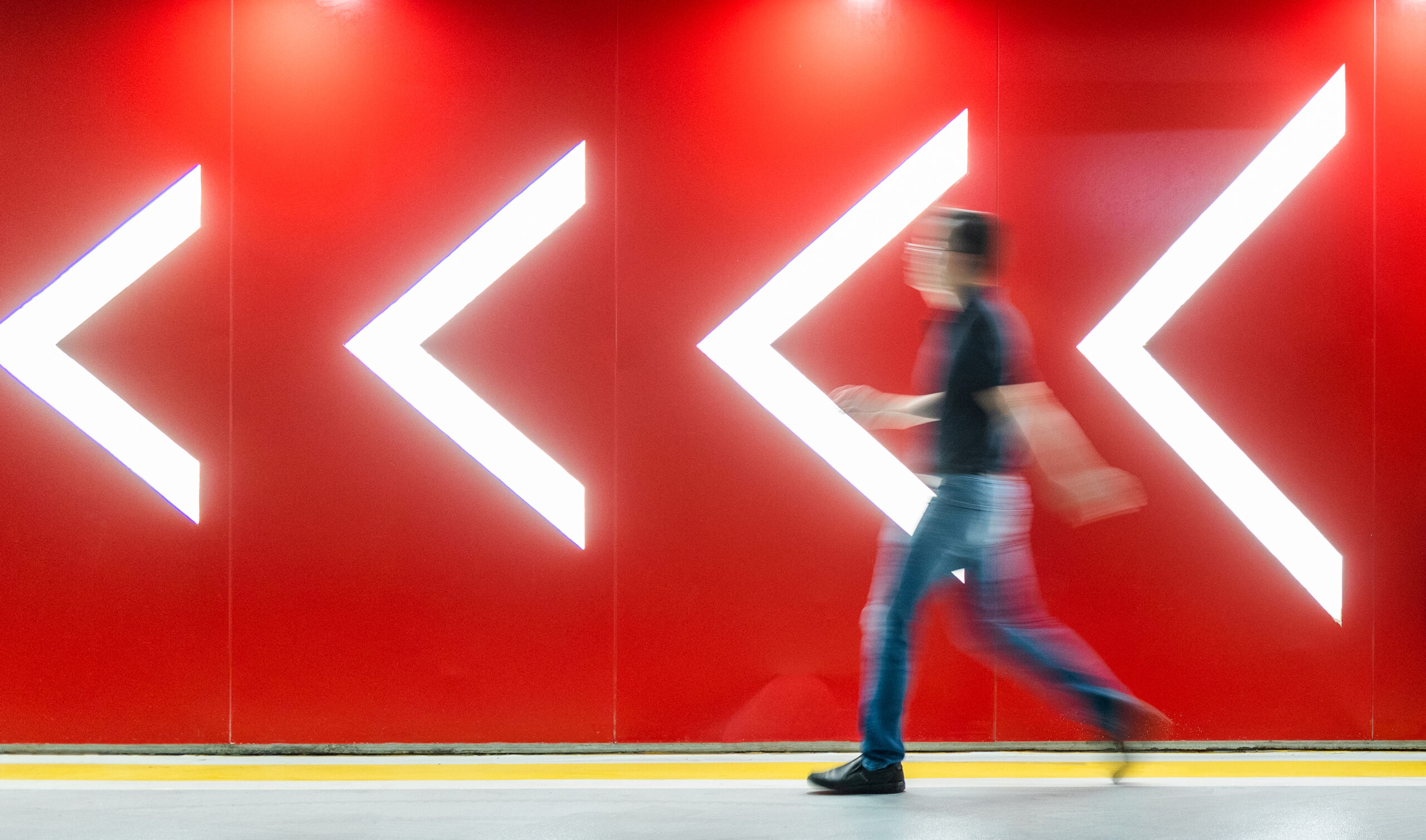 Employee walking with chevron signs implying change